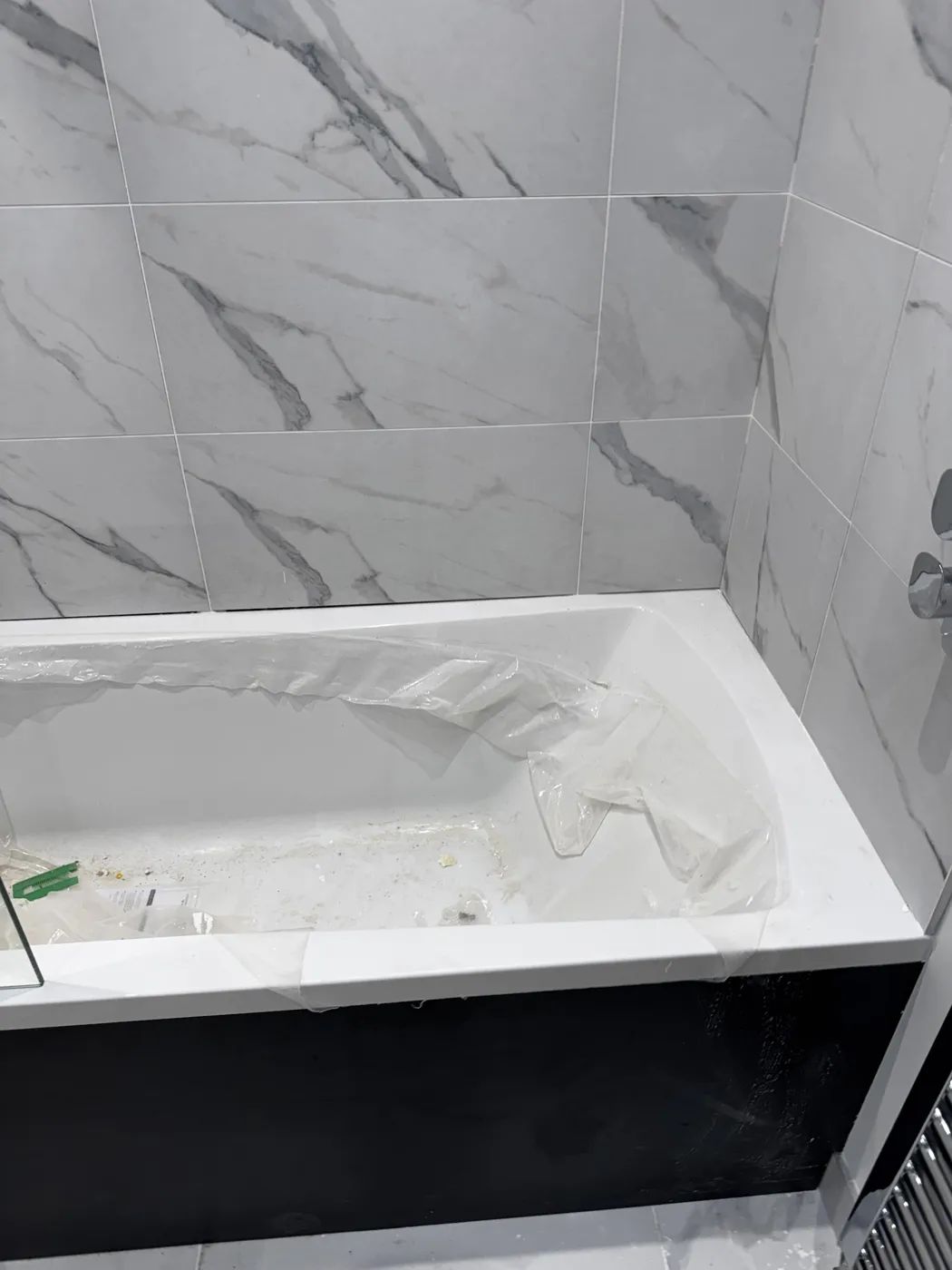 Bath full of debris before cleaning