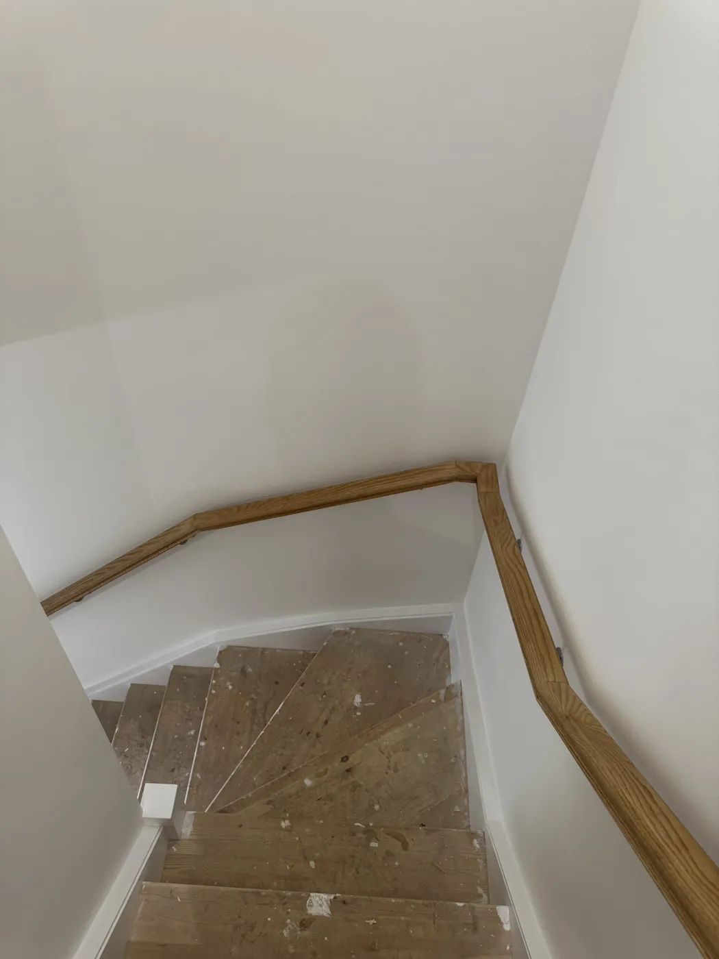 Staircase covered in paint and plaster before a builders clean