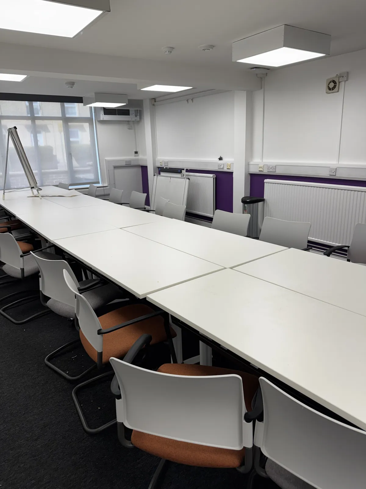 Office meeting room with tables and chairs after cleaning