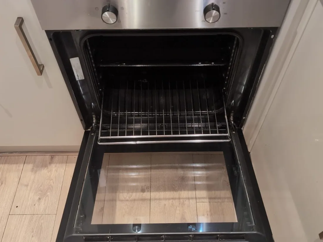 The same built-in oven after cleaning, with clear door glass and a clean interior