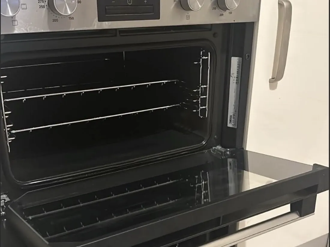 Built-in double oven after cleaning, both doors open with clean grill and main cavity