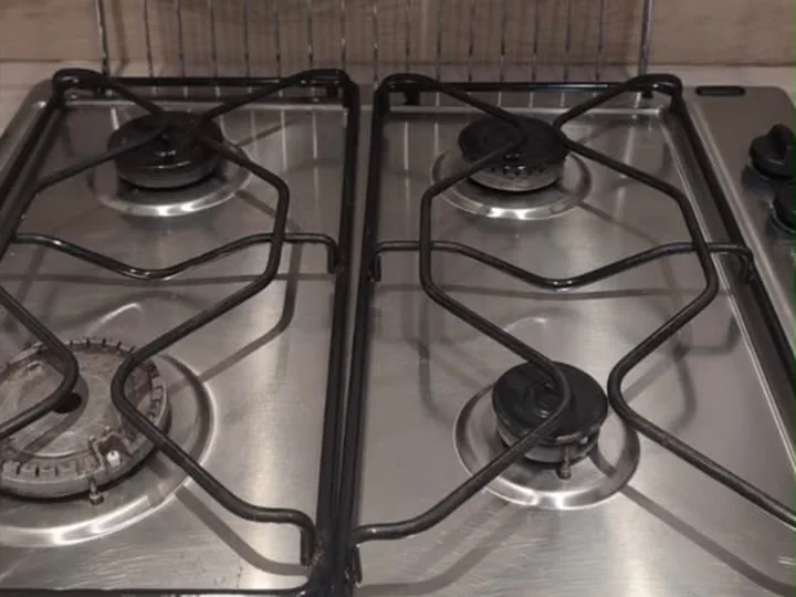 The same gas hob after cleaning, with the pan supports and burner caps refitted